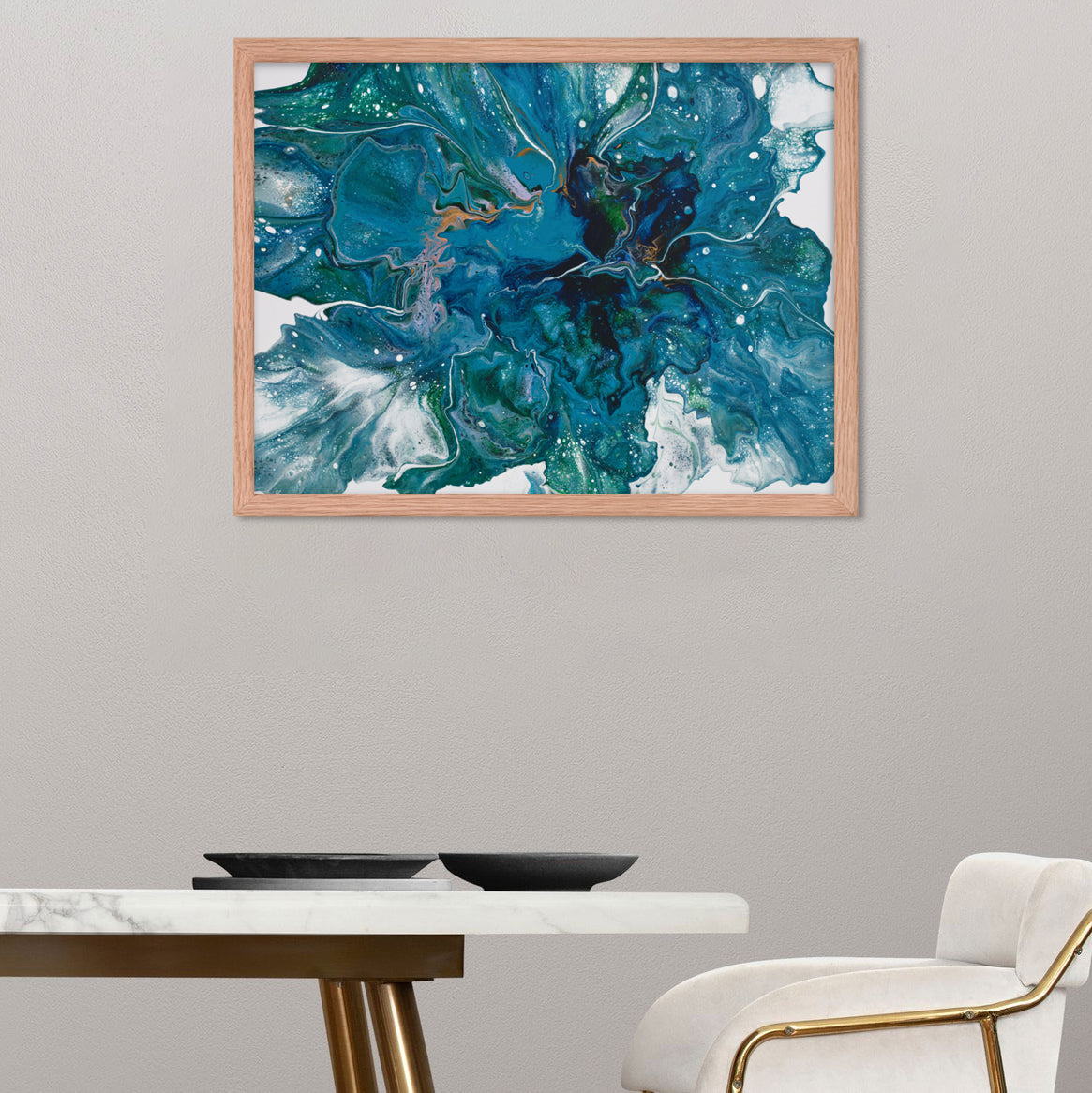 Floral acrylic pour oak frame print hanging on gray wall in front of elegant dining table and white chair.