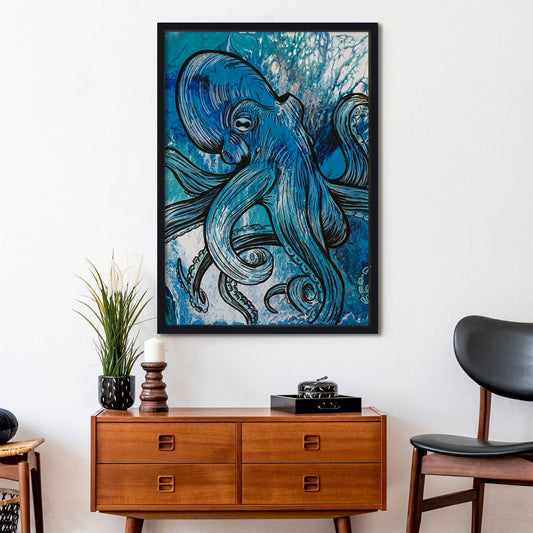 Framed blue octopus artwork on a wall above a wooden cabinet with decor items.